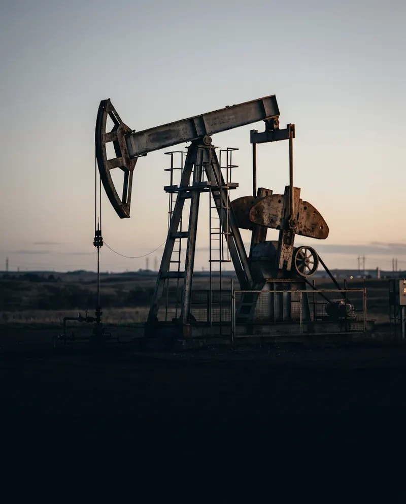Oil pump jack silhouetted at dusk